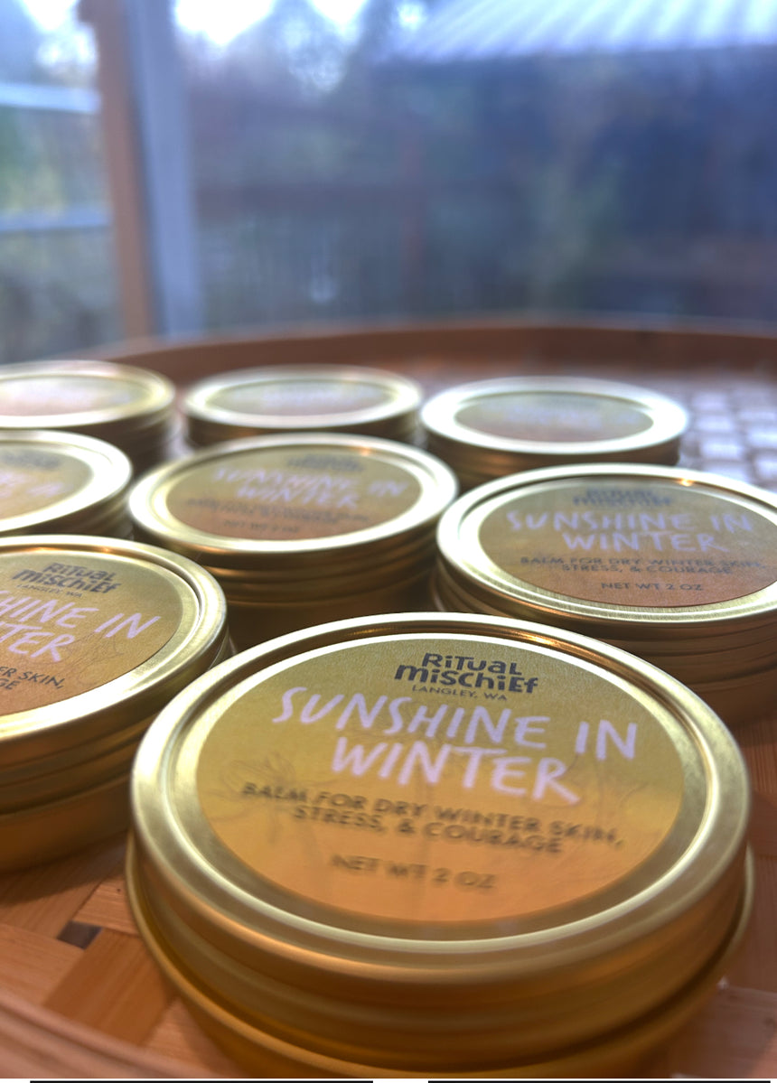 Gold tins holding Sunshine in Winter balm